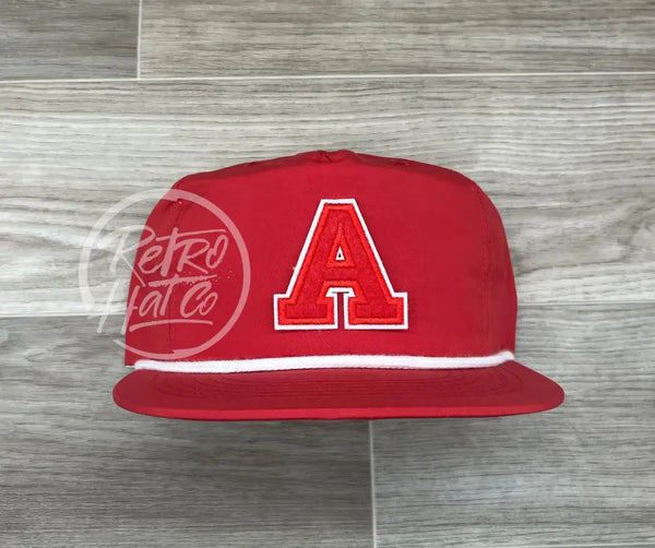 A Letter Patch On Red Poly Rope Hat Ready To Go